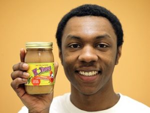 Holmes Mouthwatering Applesauce founder Ethan Holmes poses with a jar of his applesauce